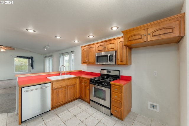 kitchen with ceiling fan, sink, light tile patterned floors, and stainless steel appliances