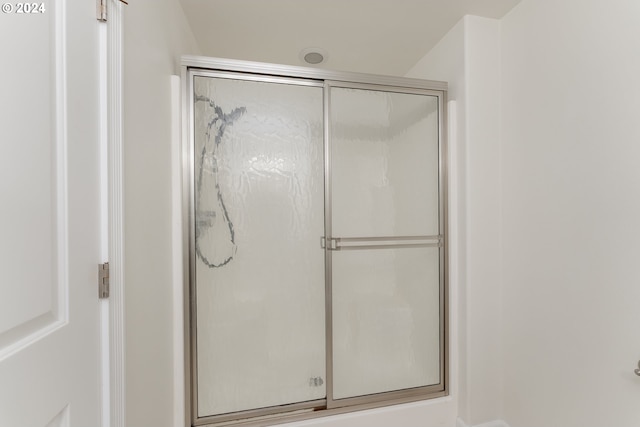 bathroom with a shower with door