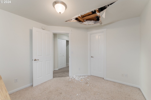 unfurnished bedroom featuring light colored carpet