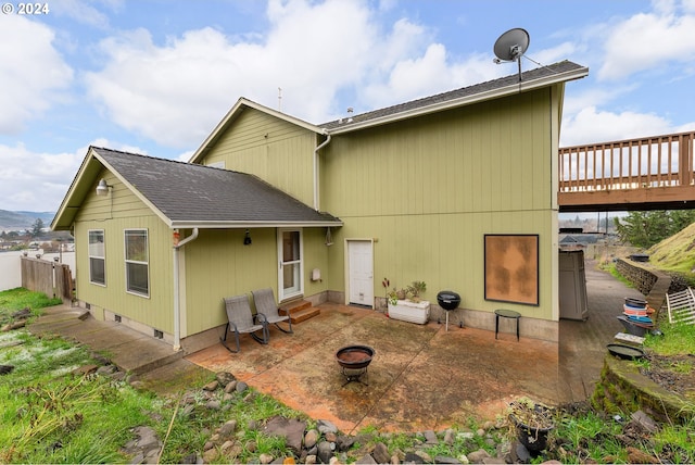 rear view of property with a deck and a patio area