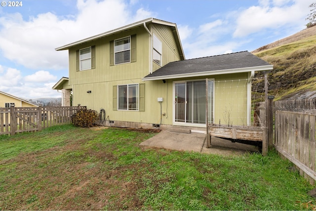 back of property featuring a yard and a patio