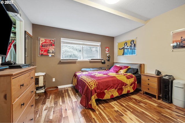 bedroom with dark hardwood / wood-style flooring