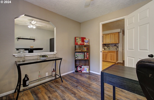 office with ceiling fan, a textured ceiling, and hardwood / wood-style floors