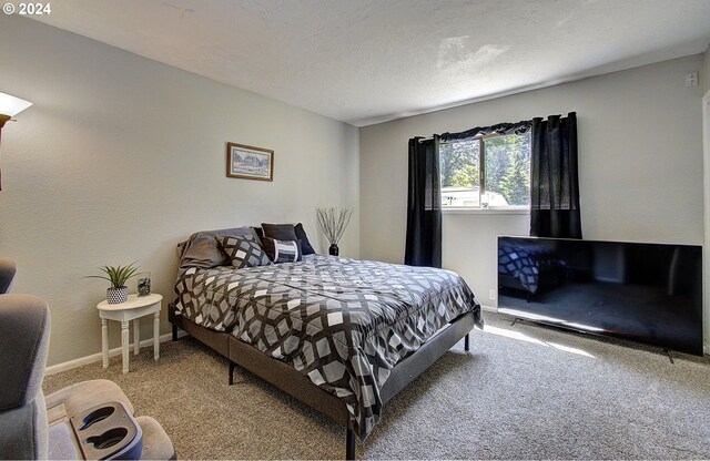 carpeted bedroom featuring a textured ceiling