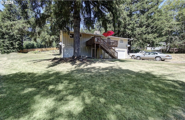 view of yard with a deck and a garage