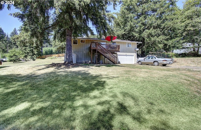 view of yard with a garage and a wooden deck