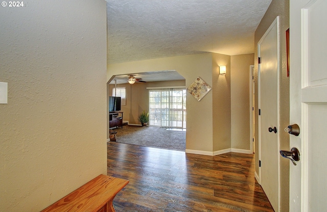 entrance foyer featuring a textured ceiling, dark hardwood / wood-style flooring, and ceiling fan