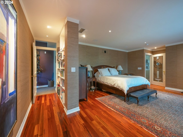 bedroom with recessed lighting, wood finished floors, visible vents, baseboards, and ornamental molding