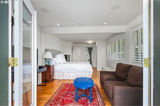 bedroom with recessed lighting and wood finished floors