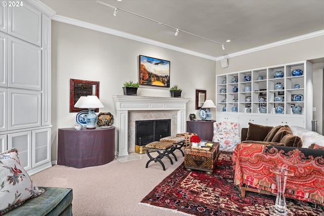 living room featuring a fireplace, carpet flooring, rail lighting, and crown molding