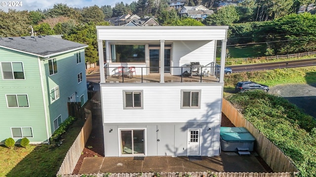 5545 NW Logan Rd, Lincoln City, OR 97367 - rear view of property with board and batten siding and a fenced backyard