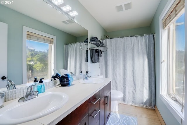 bathroom with vanity, toilet, a shower with curtain, and tile patterned flooring