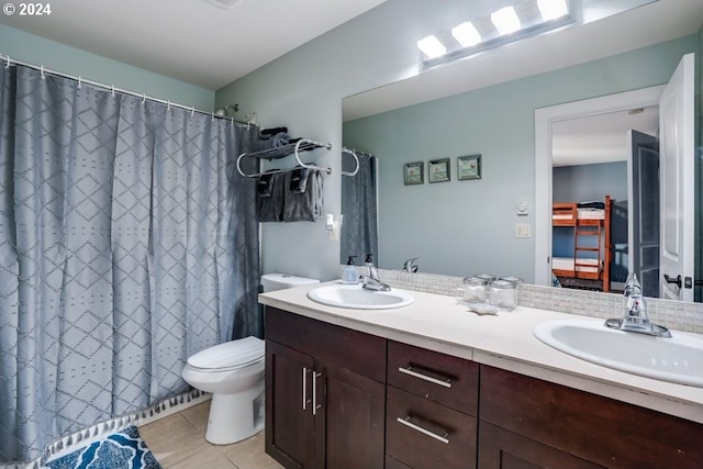 bathroom featuring vanity, toilet, tile patterned floors, and curtained shower