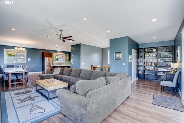 5545 NW Logan Rd, Lincoln City, OR 97367 - living area featuring baseboards, recessed lighting, wood finished floors, and ceiling fan with notable chandelier