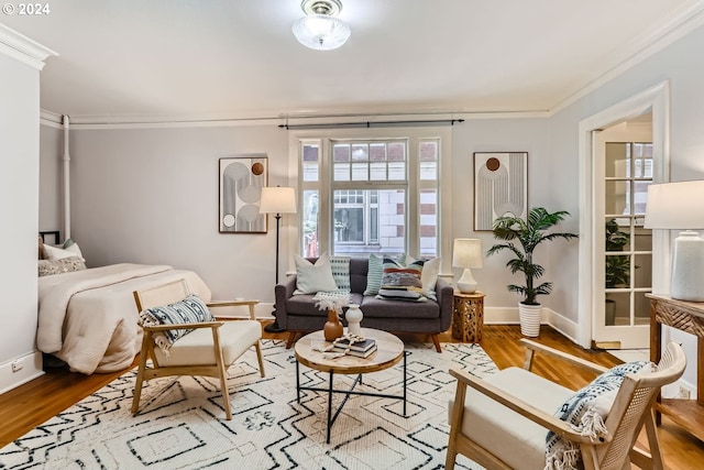 bedroom with wood-type flooring and crown molding