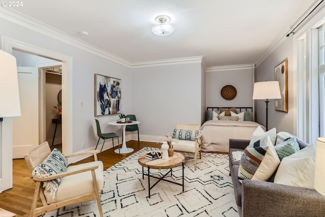 sitting room with ornamental molding and light hardwood / wood-style floors