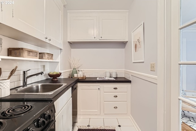 kitchen featuring dishwasher, tile patterned floors, electric range, sink, and white cabinetry