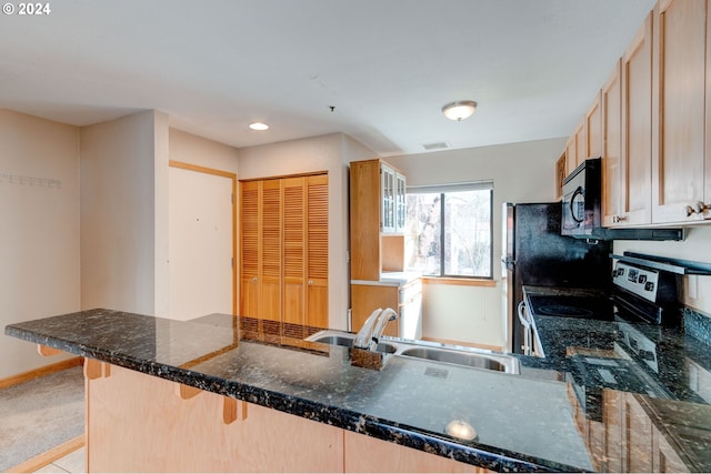 kitchen featuring light brown cabinetry, sink, kitchen peninsula, and stainless steel electric range oven