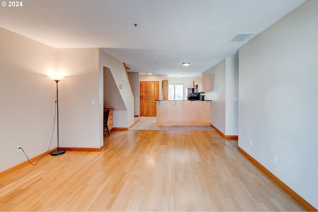 unfurnished living room featuring light hardwood / wood-style flooring