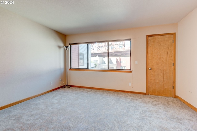 empty room with light colored carpet