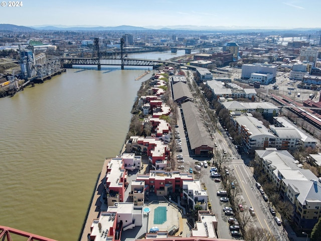 drone / aerial view with a water and mountain view