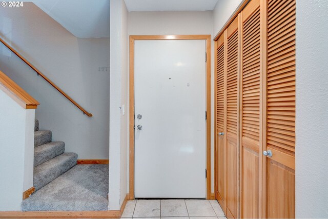 entryway with light tile patterned flooring