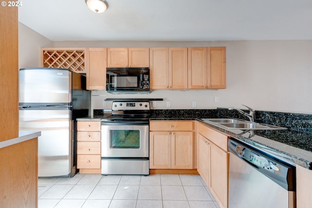 kitchen with sink, light tile patterned floors, stainless steel appliances, and light brown cabinets