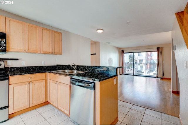 kitchen with light tile patterned flooring, appliances with stainless steel finishes, kitchen peninsula, and sink