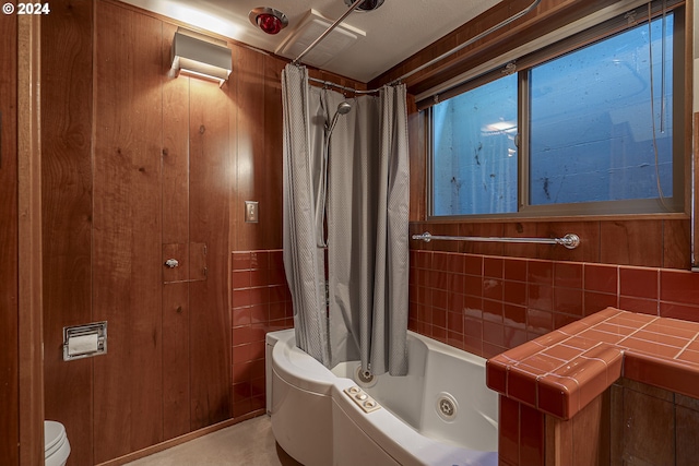 bathroom featuring shower / tub combo and toilet