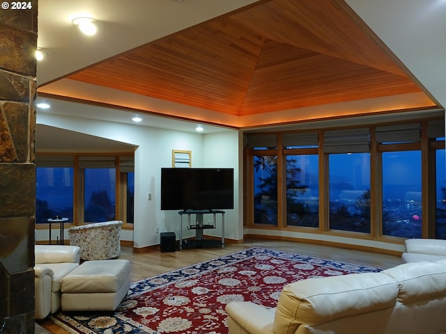 living room with a tray ceiling, wooden ceiling, and wood-type flooring