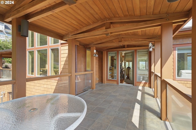 sunroom / solarium with a healthy amount of sunlight and wood ceiling