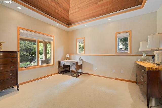 office area featuring a tray ceiling, light colored carpet, and wood ceiling