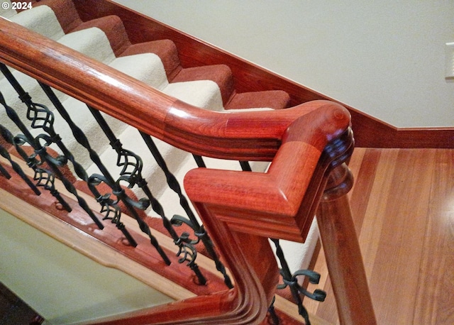 stairs featuring hardwood / wood-style flooring