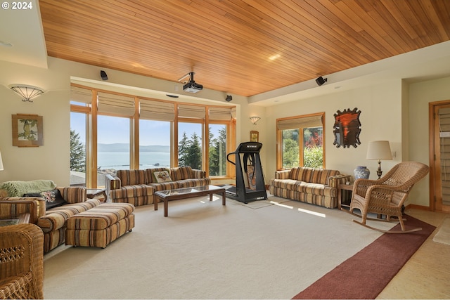 living room with carpet, a water view, and wood ceiling