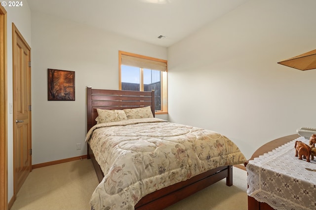 bedroom featuring light colored carpet