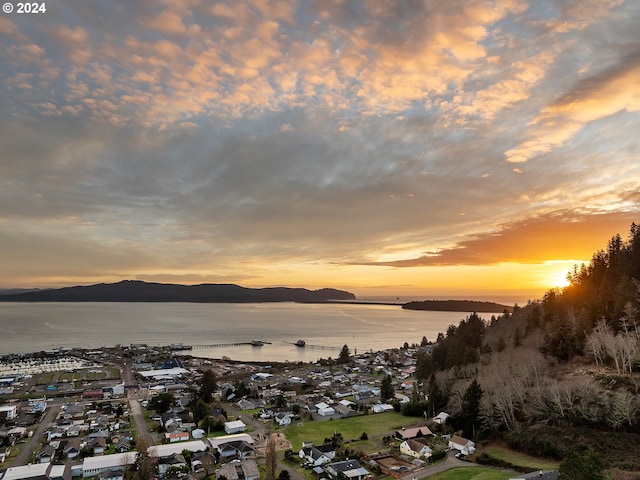 aerial view at dusk with a water and mountain view