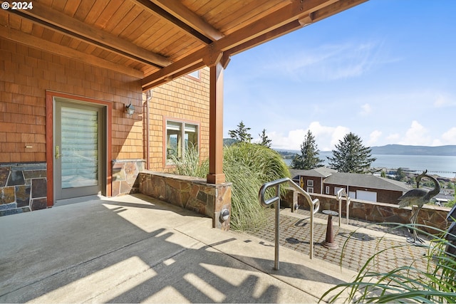 view of patio with a water and mountain view