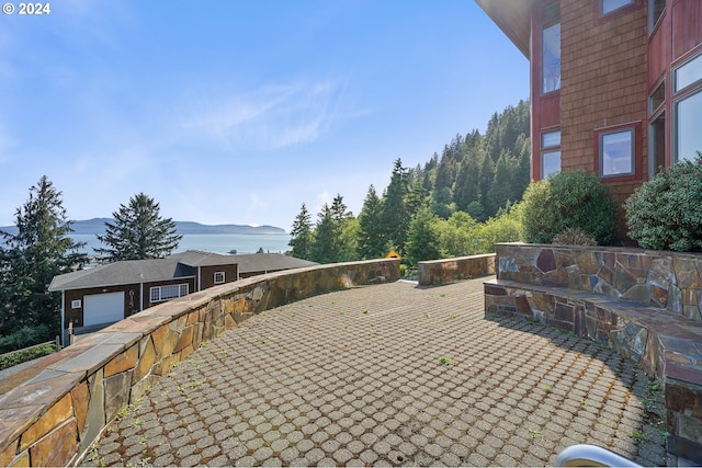 view of patio with a mountain view and a garage