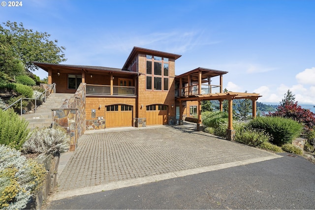 view of front of property featuring a balcony and a garage