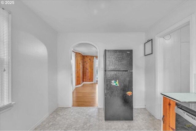 laundry room with wood walls and independent washer and dryer