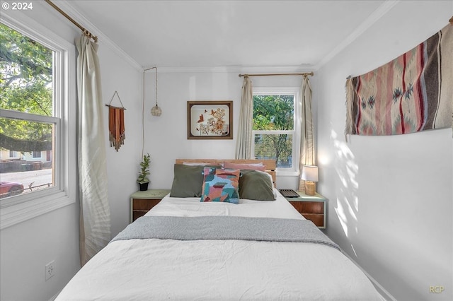 bedroom with multiple windows and crown molding