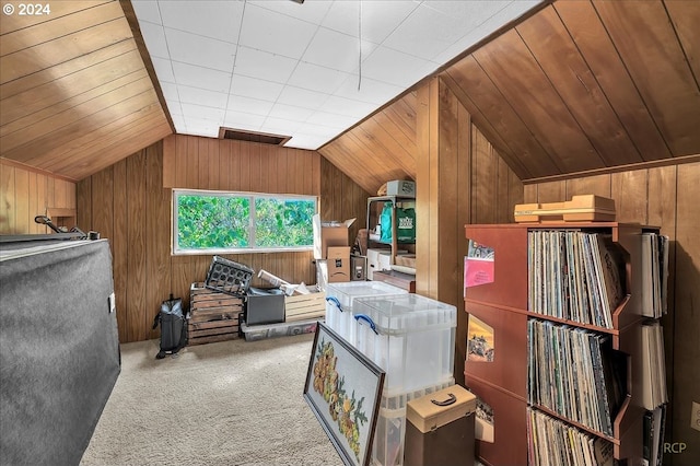 bonus room with carpet, wooden walls, and vaulted ceiling