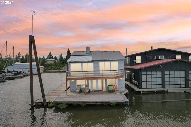 dock area featuring a deck with water view