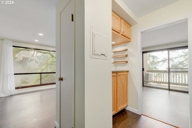 kitchen with black appliances, light stone countertops, dark wood-type flooring, and sink