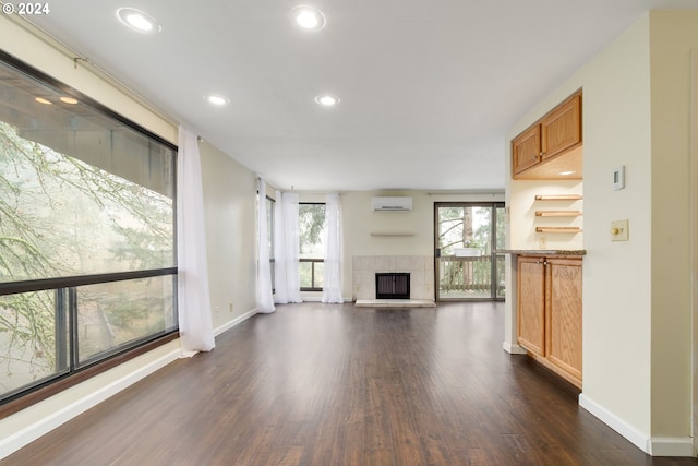 entrance foyer with a fireplace, dark hardwood / wood-style floors, and an AC wall unit