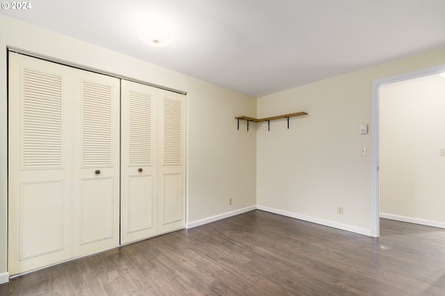 empty room with dark wood-type flooring