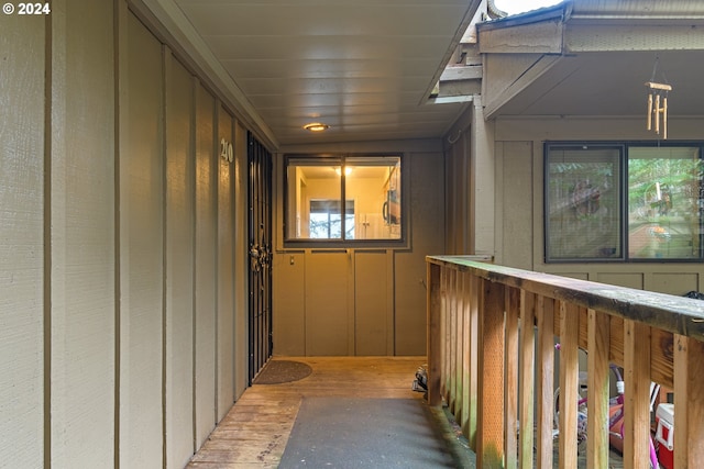 hallway with hardwood / wood-style flooring