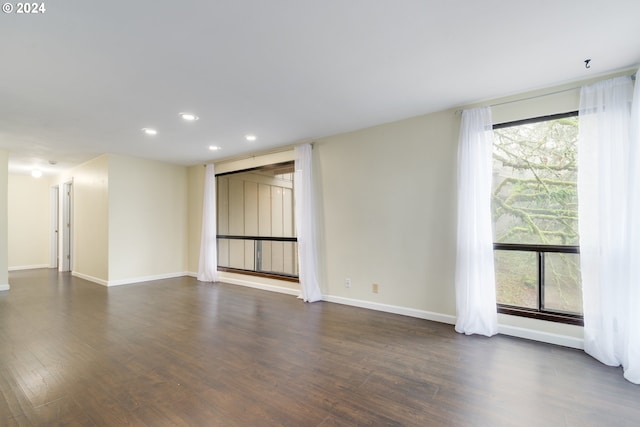 unfurnished room featuring dark wood-type flooring