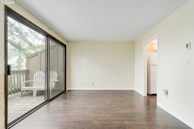 empty room with dark hardwood / wood-style floors