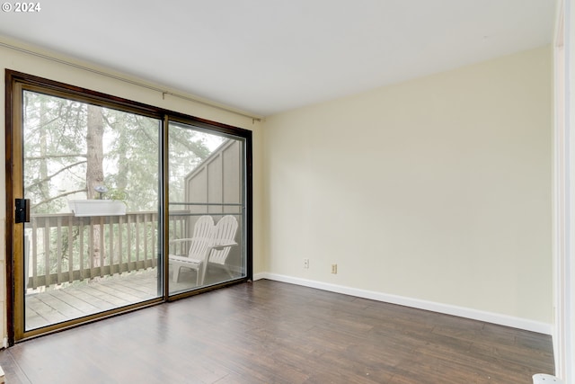 unfurnished living room featuring a tile fireplace, a wall mounted air conditioner, and dark hardwood / wood-style flooring